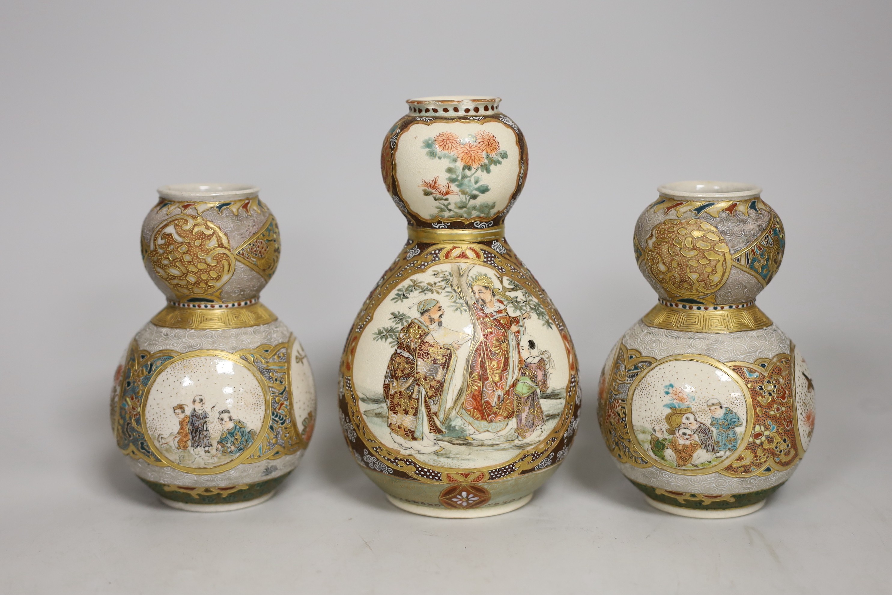 A pair of Japanese Satsuma pottery double gourd shaped vases another similar single vase,. Tallest 15cm